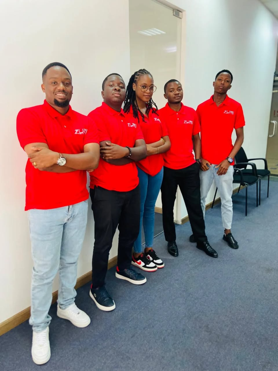 Zuri Motors sales team in red branded polo shirts
