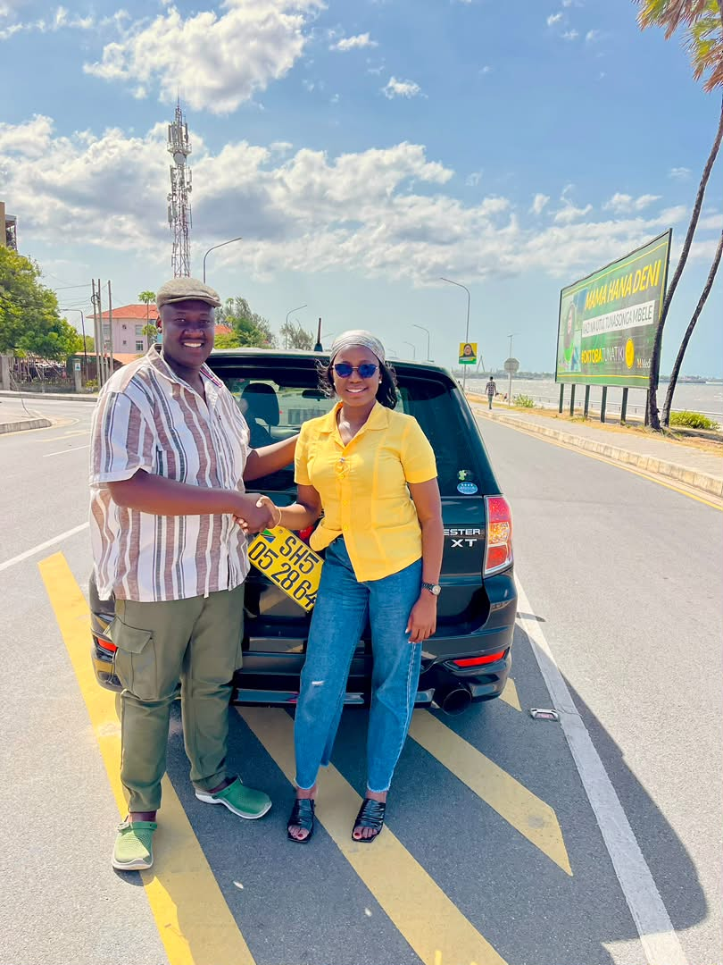 Zuri Motors customer receiving keys for a Subaru Forester XT in Dar es Salaam