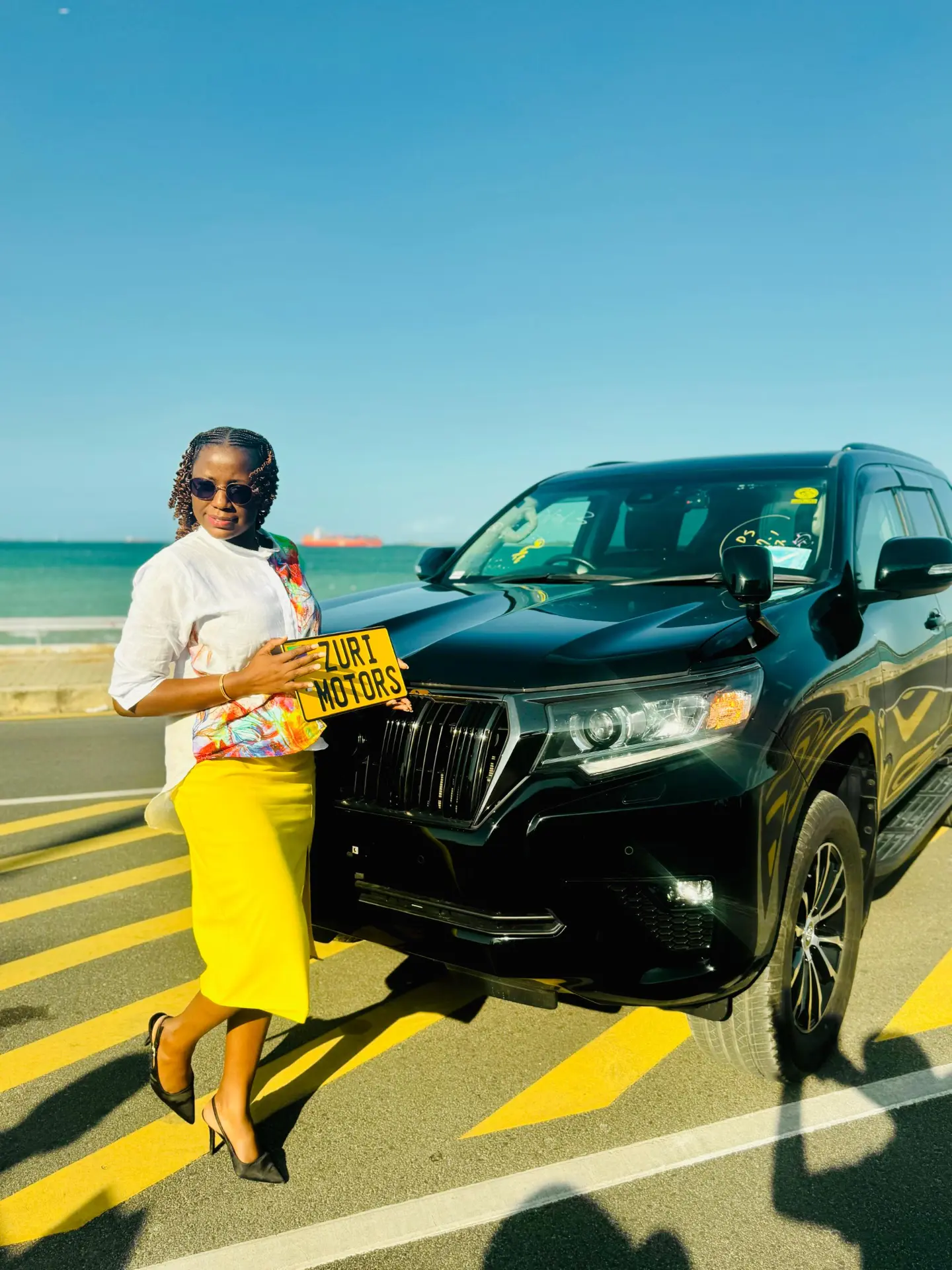 Zuri Motors number plate presented with a delivered Toyota Land Cruiser Prado