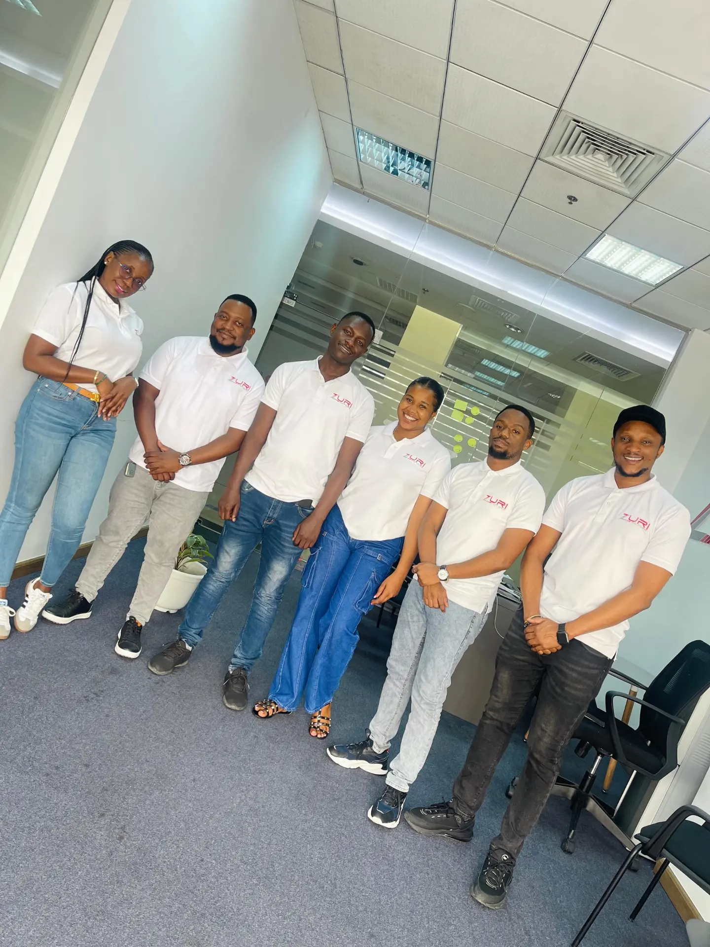 Zuri Motors sales team in white branded polo shirts