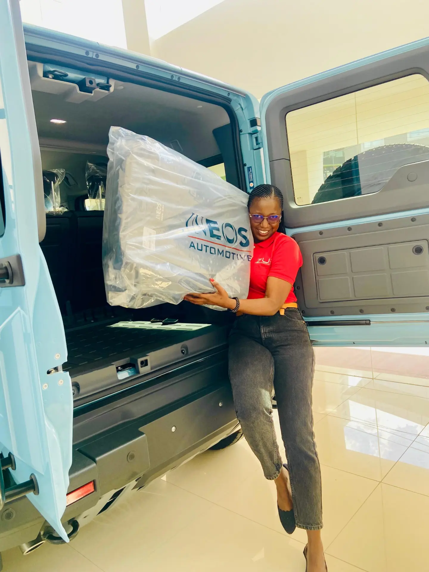 Zuri Motors staff preparing a newly delivered Ineos vehicle for handover